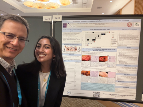 Dr. Nghiem and trainee by poster 