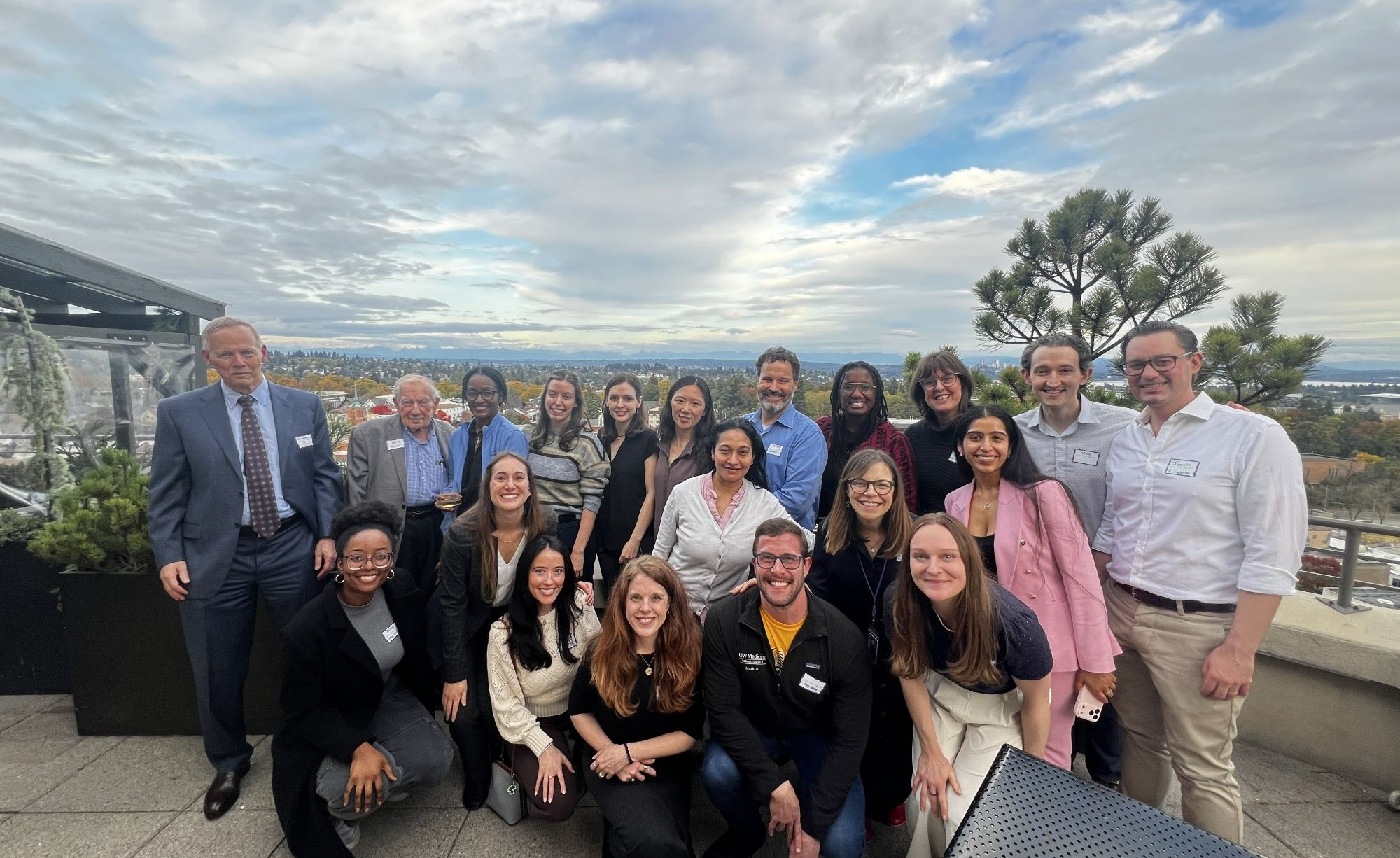 Group of people standing on a rooftop patio